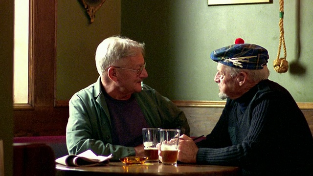 两名中年男子坐在酒吧里聊天喝啤酒/一个在塔姆奥香特/新斯科舍省视频素材