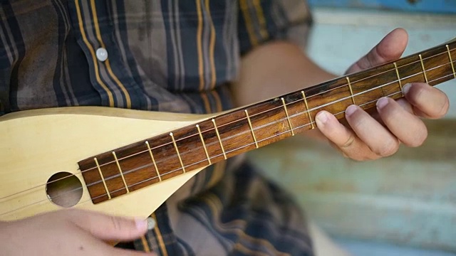 一位音乐家在古老的房子里弹奏曼陀林。视频下载