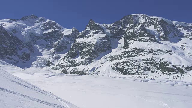 在冰川或群山环绕的新雪上滑雪视频素材