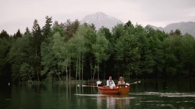 一对新婚夫妇在湖上划船视频素材