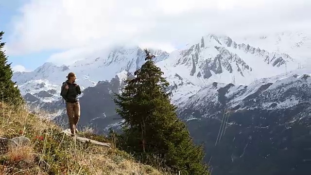 男性徒步者沿着小路穿过山坡，雪山视频素材