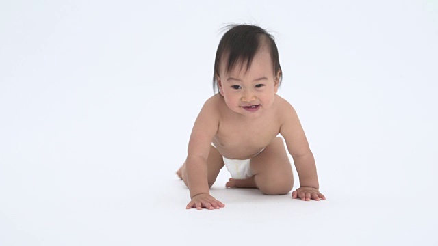 婴儿在白色的背景上爬行视频素材