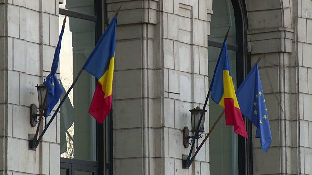 罗马尼亚布加勒斯特议会大厦外悬挂着罗马尼亚国旗和欧盟国旗。视频下载