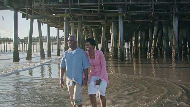 一对快乐的非裔美国夫妇在圣塔莫尼卡码头附近散步视频素材