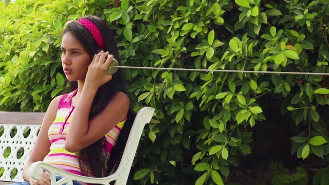 十几岁的男孩和女孩在一个罐头电话，德里，印度视频素材