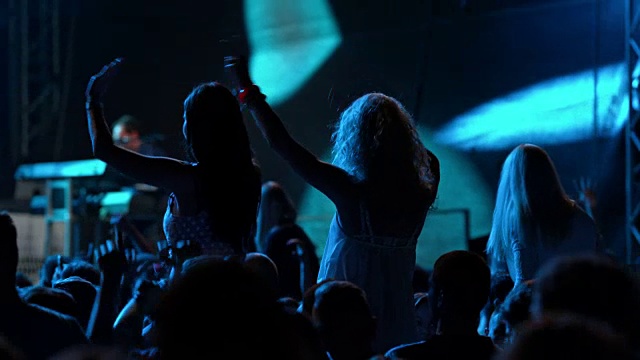在音乐会上，女人坐在男人的肩膀上聚会视频素材