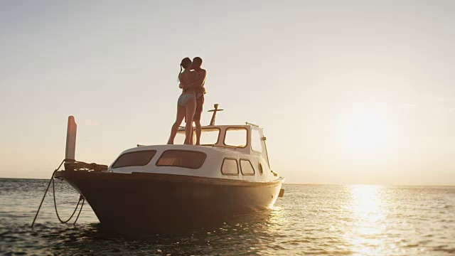 日落时分，一对情侣在船上接吻视频素材