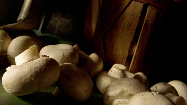 MS倾斜蘑菇落在灰色的表面，背景是一篮蘑菇视频下载