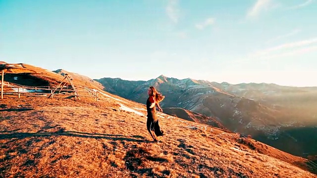日出时，一个年轻女子在山顶做瑜伽视频素材