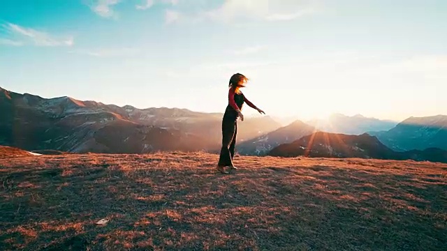 日出时，年轻女子在山顶跳舞视频下载