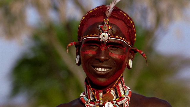 肯尼亚的马赛部落男子转过身看着镜头，脸上涂着油彩视频下载