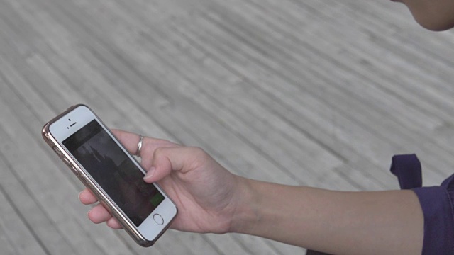 女人在户外使用智能手机的特写视频素材