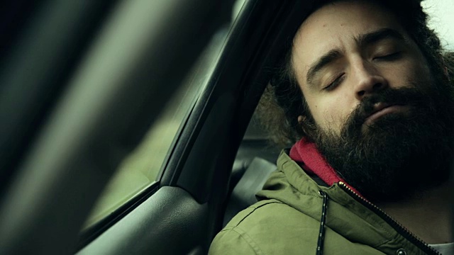 男人睡在车里视频素材