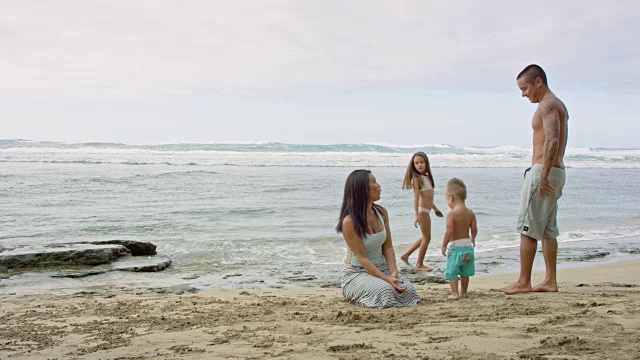 混血家庭在海边的沙滩上玩耍视频素材