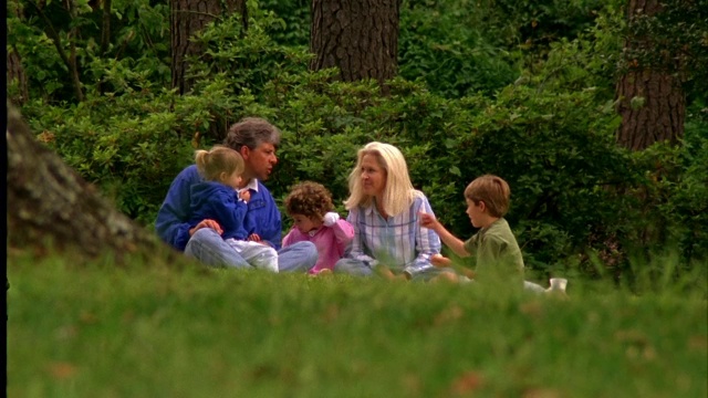 一家人在公园里享受野餐。视频素材