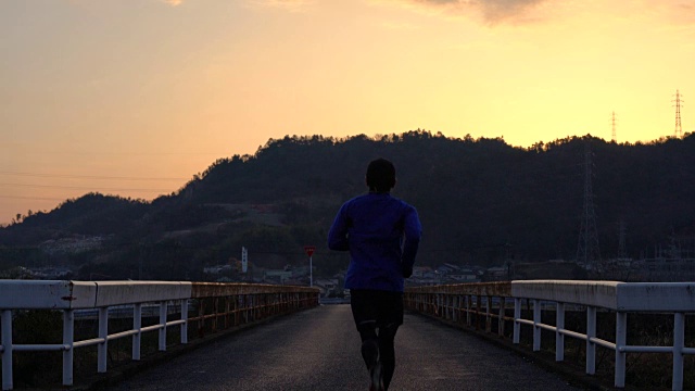 一个中年男子在早晨跑步的广角镜头视频素材