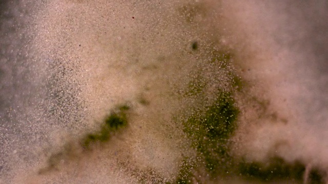 沙子被扔向摄像机的慢动作镜头。视频素材