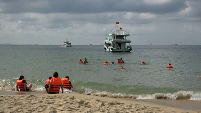 人们穿着救生衣在海滩和游艇上视频下载