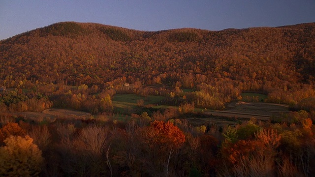 从空中俯瞰农田和秋天的树木，背景是山脉/新英格兰视频素材