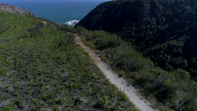 鸟瞰图的年轻女子徒步在山谷的海边，南非视频素材