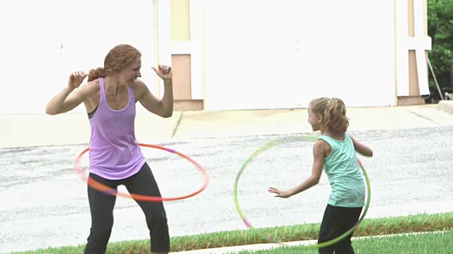 母亲和女儿玩呼啦圈视频素材