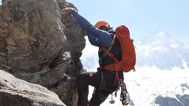 男性登山者攀登垂直岩壁以上的mtns，山谷视频素材