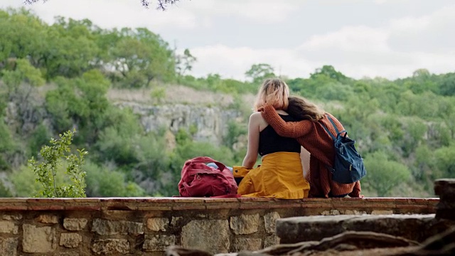 两姐妹拥抱，从国家公园的风景俯瞰山谷。视频素材
