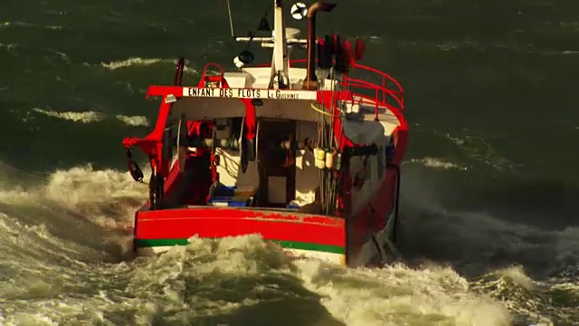 法国，布列塔尼:一艘破浪前行的小渔船视频下载