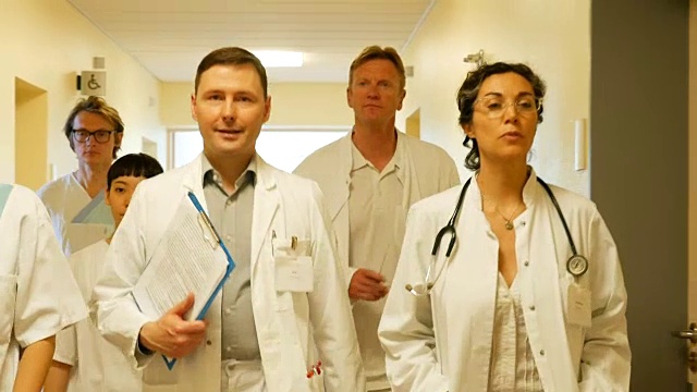 自信的医生和护士走在走廊上视频下载