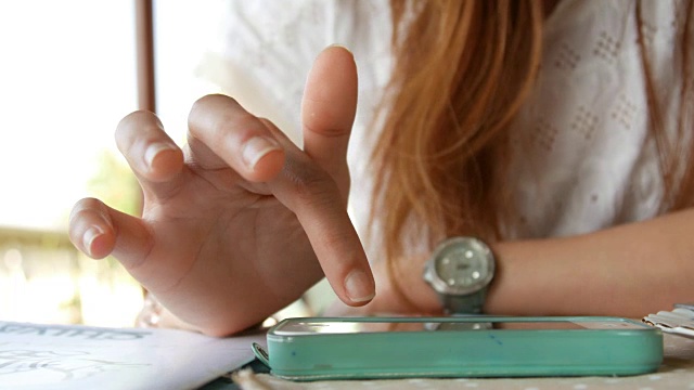 一名年轻女子在智能手机上使用触摸屏技术视频素材