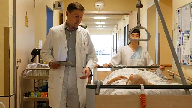 医生和护士由病人在医院轮床上视频下载