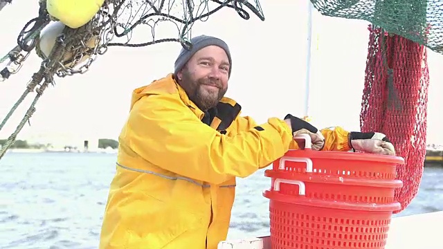 在商业渔船上堆放篮子的工人视频下载