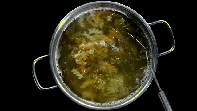 在沸腾的锅中搅拌蔬菜意大利面——顶部击球视频素材