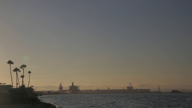 中等角度的海军船只或军事船只在圣地亚哥港或海湾。在fg海滩上的人们。视频下载