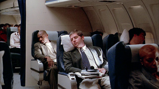 在飞机上睡觉的乘客/空乘人员提供男性枕头视频下载