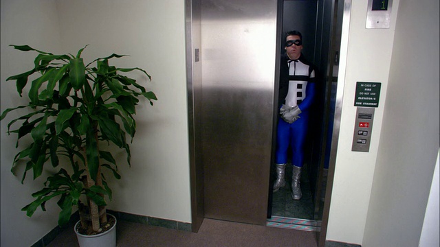 (广角镜头)商人等电梯/与小丑和超级英雄一起进入电梯/洛杉矶视频素材