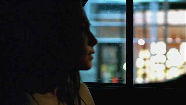 一名女子坐在出租车后座上望着窗外视频下载