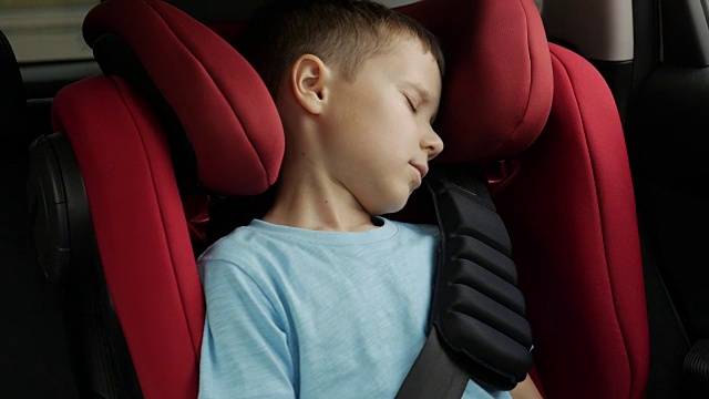 小男孩在开车时安静地睡在婴儿座椅上视频下载