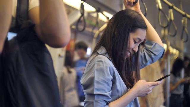 年轻女子在火车上用手机上网，慢镜头视频素材