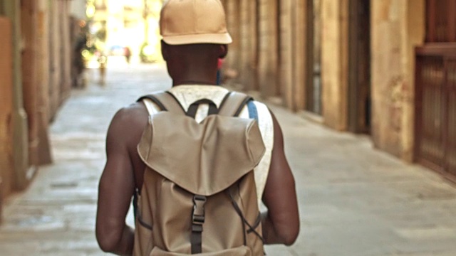 一个非洲青年走在城市里视频素材