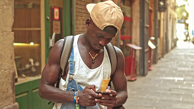 一名非洲青年在大街上用手机发送短信视频素材