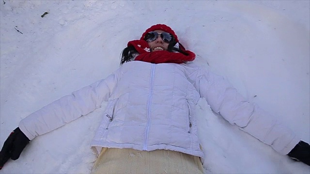 年长的女人做了一个雪天使视频素材