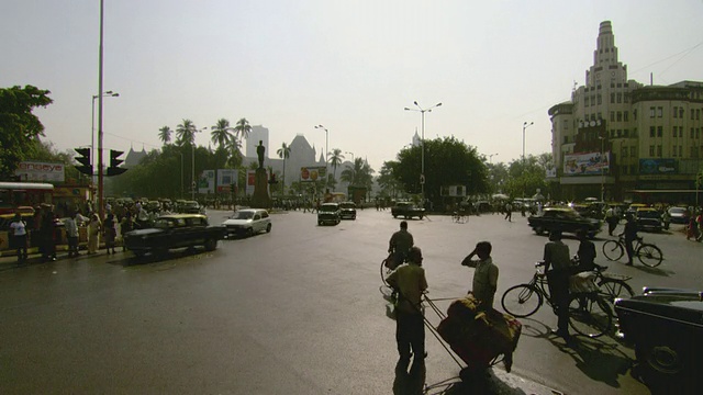 交通和行人穿过繁忙的城市十字路口/印度视频素材