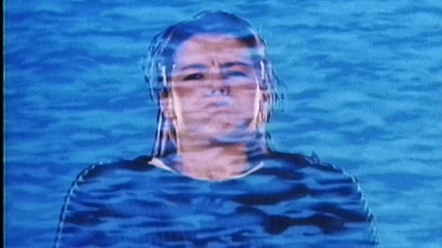 1987年合成的年轻女子屏住呼吸，水和鱼的动画叠加在她身上视频下载