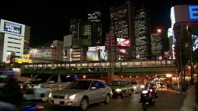 低角度广角拍摄新宿火车轨道下的交通和建筑物背景/日本东京视频下载