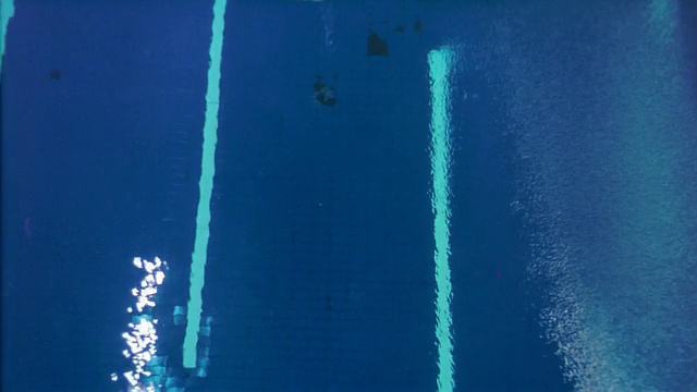 从跳水者的视角跳下室内游泳池的平台，然后翻筋斗跳入水中视频下载