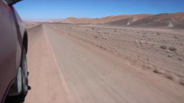 汽车轮胎穿过沙漠景观，圣佩德罗德阿塔卡马，埃尔罗亚，智利视频素材