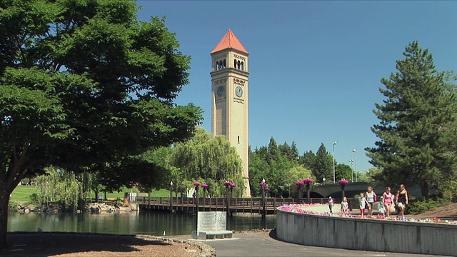美国华盛顿州斯波坎市，人们在公园里散步，背景是钟楼视频下载