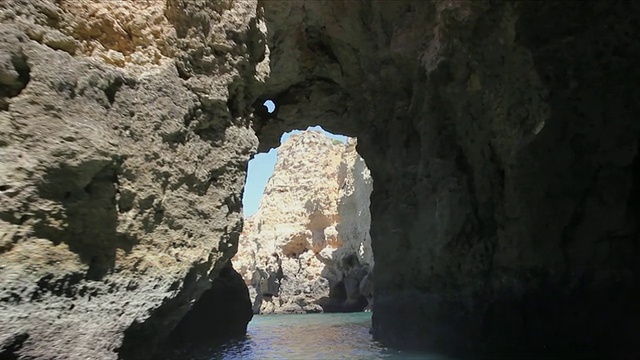 在普拉亚多纳阿纳，大西洋海岸/葡萄牙，航行通过岩石洞穴和悬崖视频下载