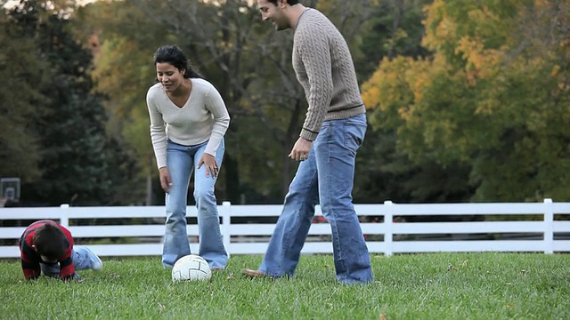 WS PAN父母和儿子(2-3)在后院踢足球/里士满，弗吉尼亚州，美国视频素材
